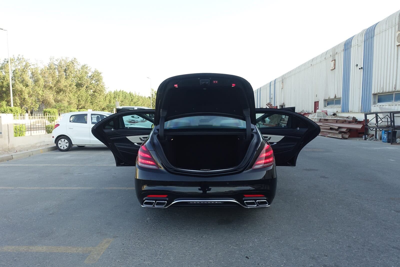 Mercedes S63 AMG armored luxury sedan rear view with all doors open