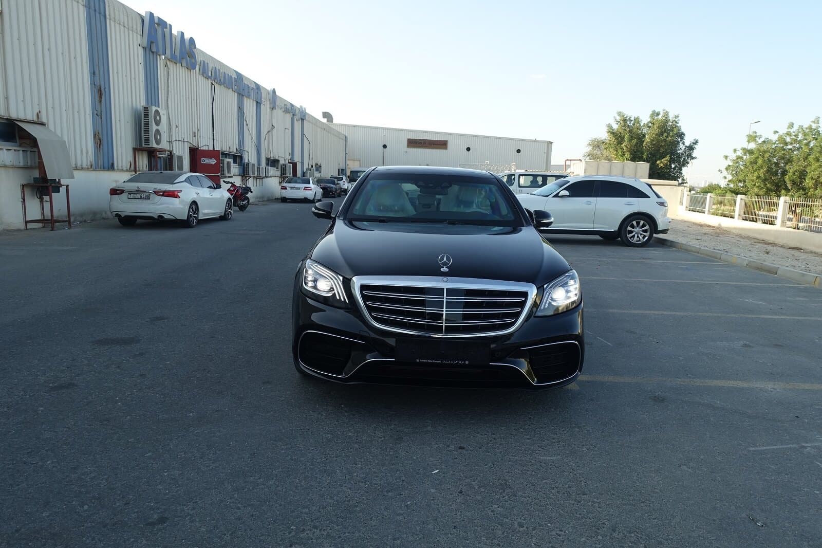 Mercedes S63 AMG armored luxury sedan front view with lights on