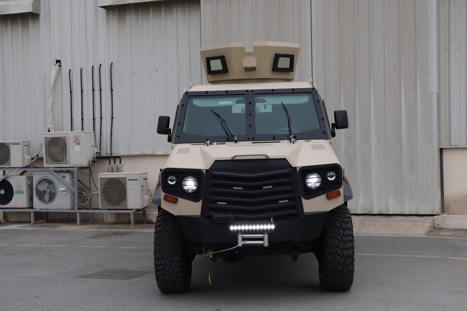 APC 6x6 Tygra front view with lights on and armored exterior