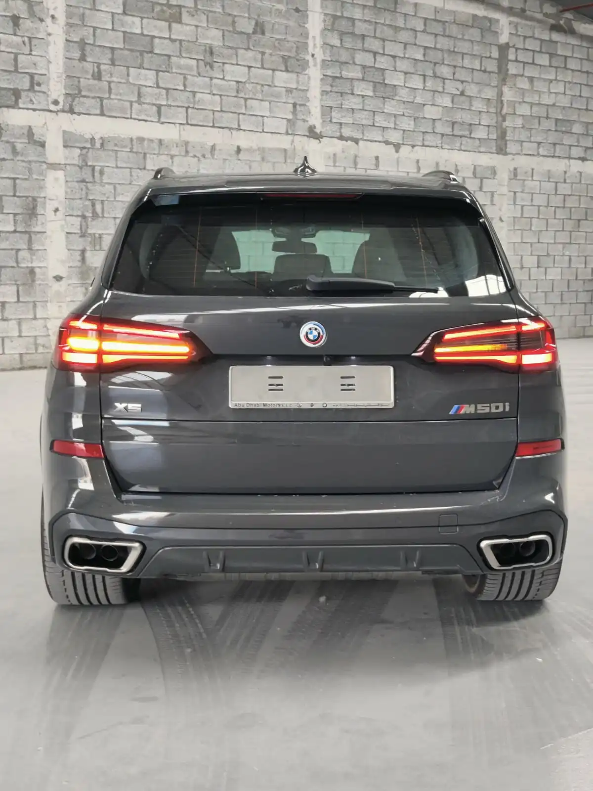 BMW X5 M50i grey armored luxury SUV rear exterior view