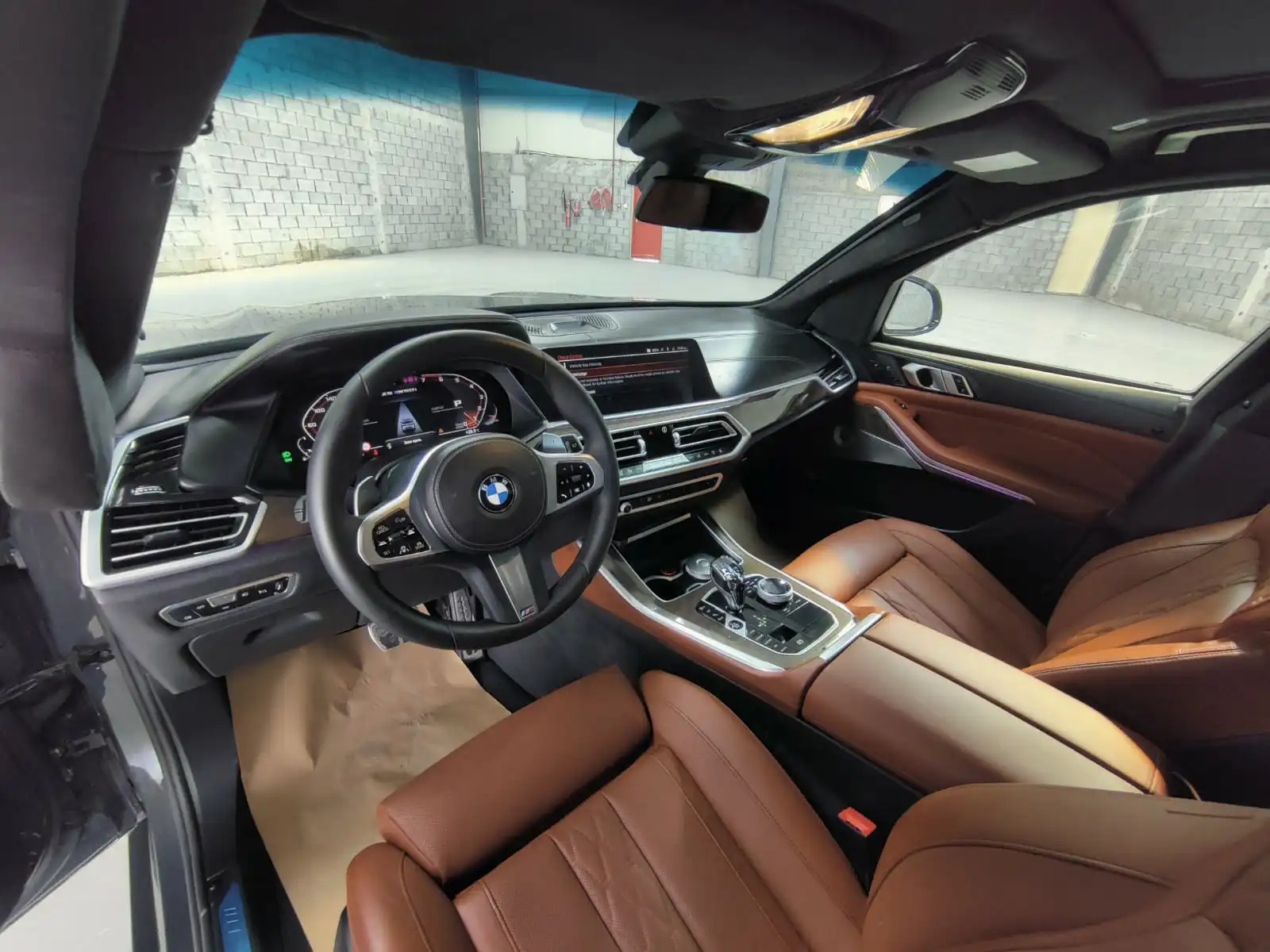 BMW X5 M50i grey armored luxury SUV cockpit interior view