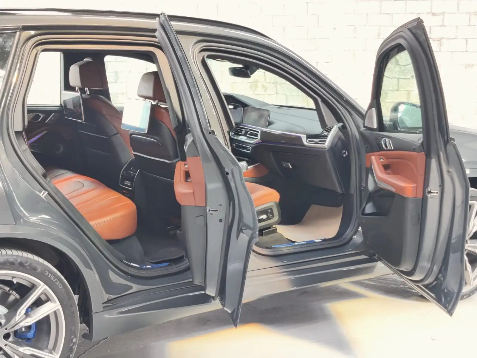 BMW X5 M50i grey armored luxury SUV left side with all doors open