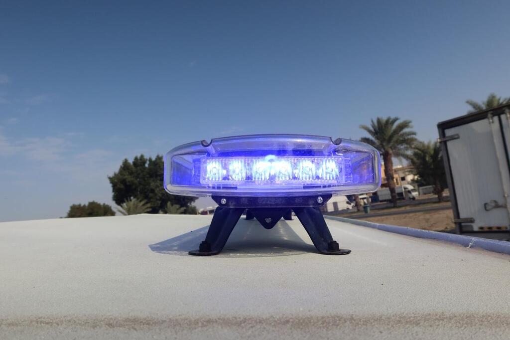 Blue emergency light bar mounted on LC79 Troop Carrier roof