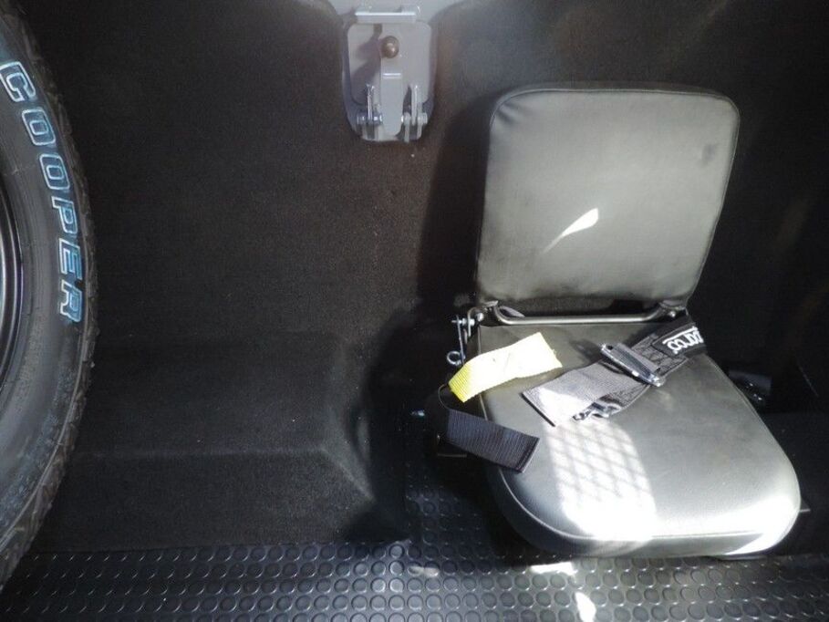 Fold-down jump seat with safety harness in LC79 Vault secure compartment