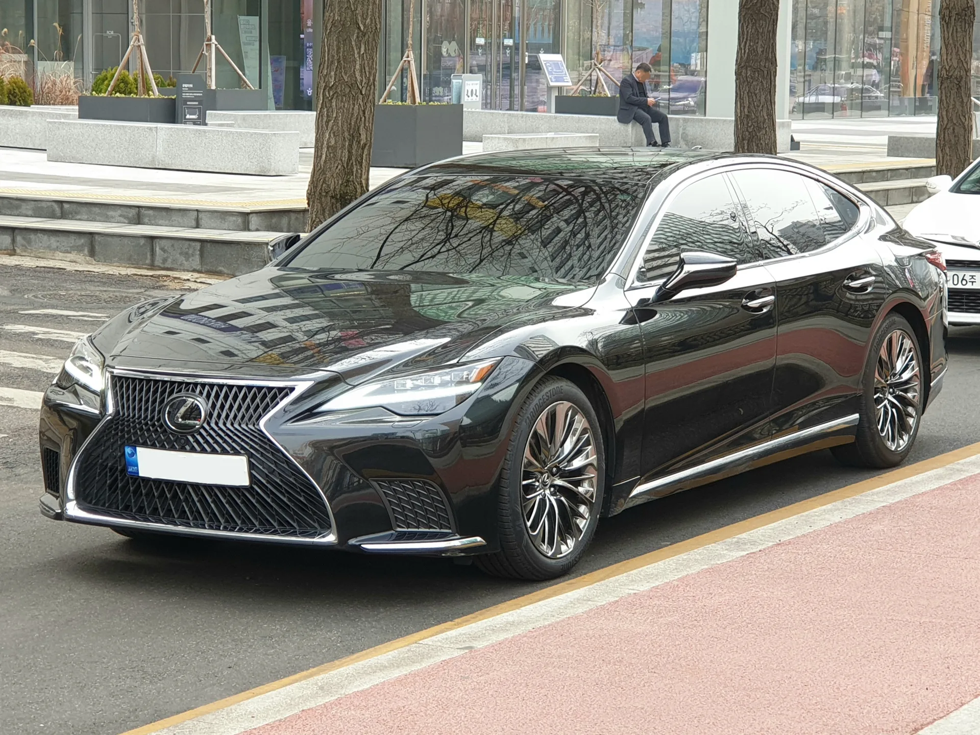 Black current-generation Lexus LS facelift sedan shown from the front left