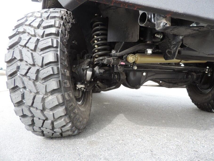 Low-angle view of LC79 security vehicle with bull bar and LED lighting