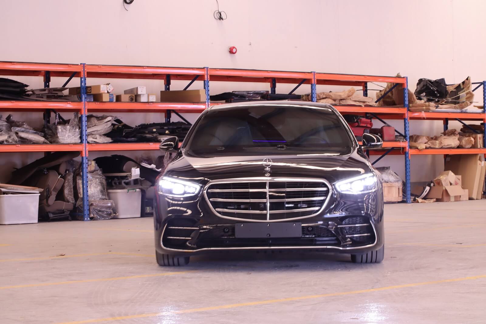 Mercedes-Benz S500 armored luxury sedan front view with lights on