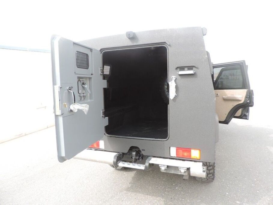 Rear vault doors open showing secure transport compartment in LC79 Troop Carrier