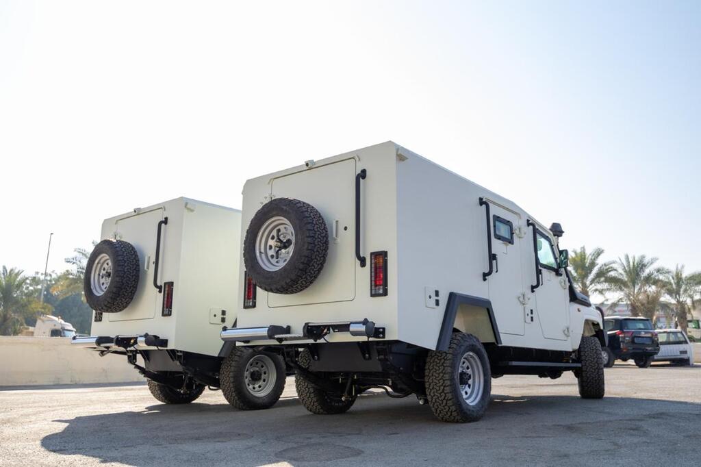 Rear view of Toyota LC79 Troop Carriers with spare tire mounts and all-terrain tires