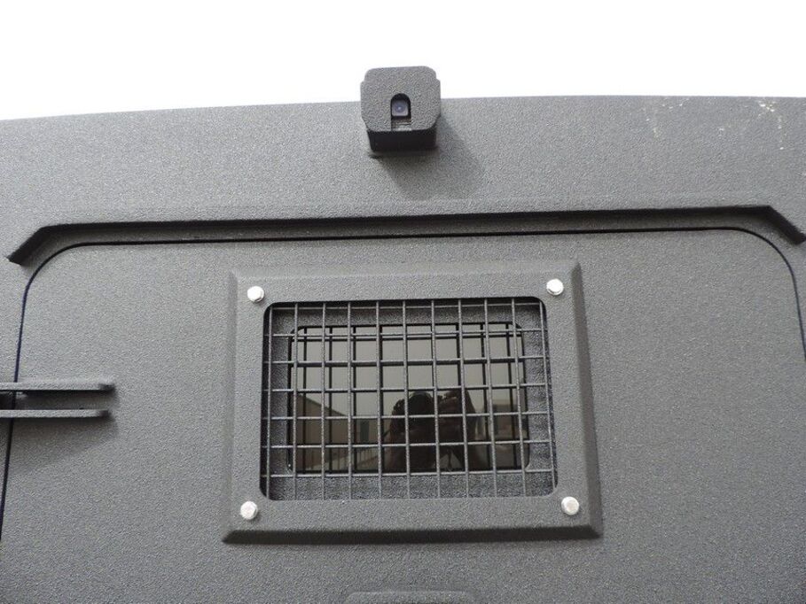 Reinforced viewing port with protective mesh grid on LC79 Troop Carrier Vault