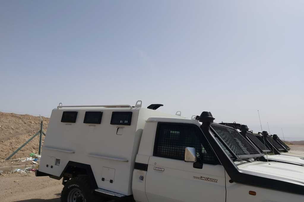 Side profile of Toyota Land Cruiser 70 specialized security vehicle with armored personnel compartment