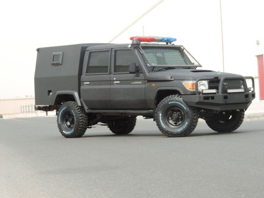 Side view of LC79 Secure Transport with police lights and protective windshield
