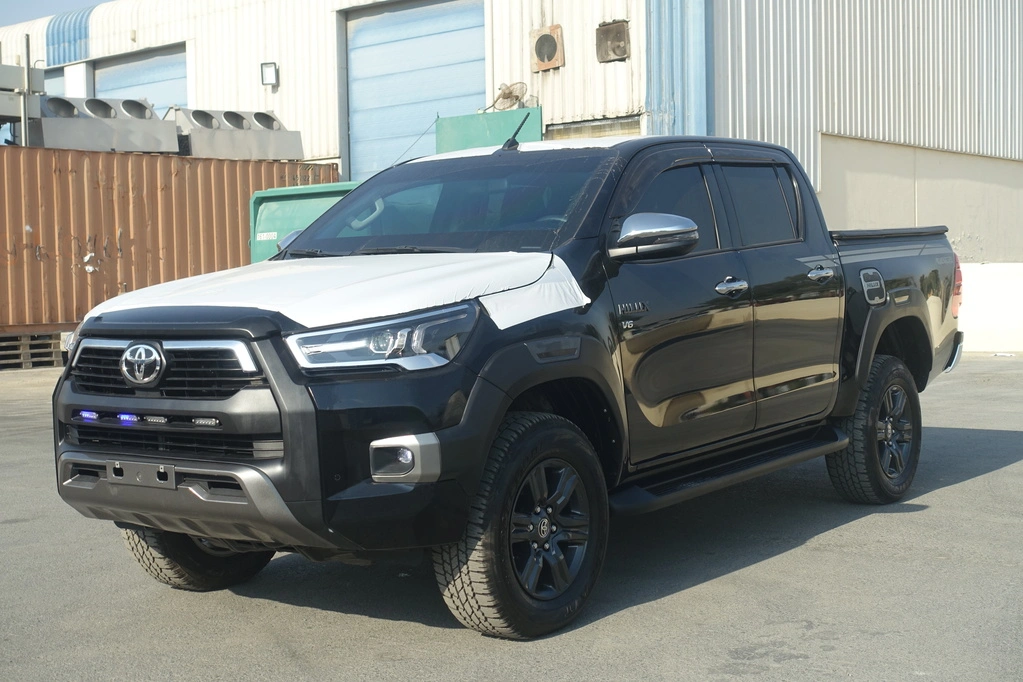 Black Toyota Hilux Adventure SR5 protected pickup in front three-quarter view
