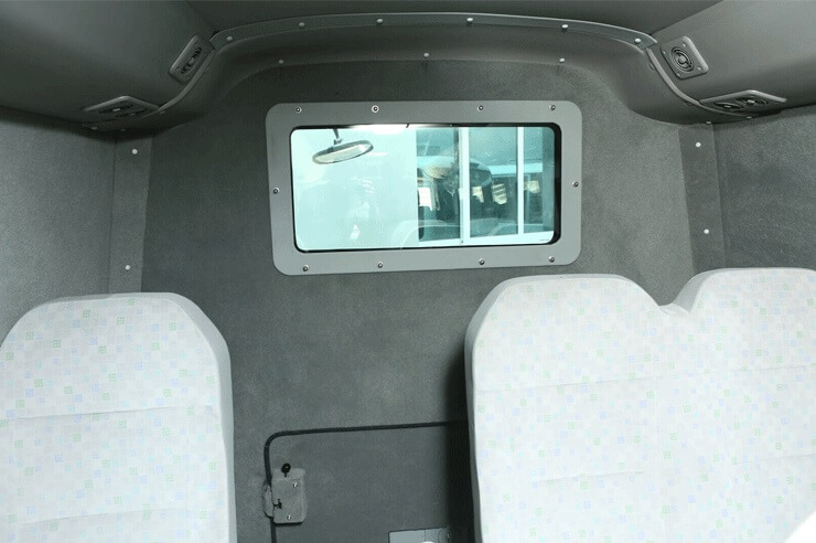 Toyota Coaster armored passenger carrier rear row seating view
