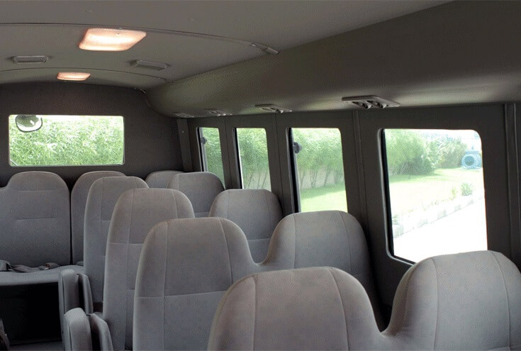 Toyota Coaster armored passenger carrier left passenger seating view