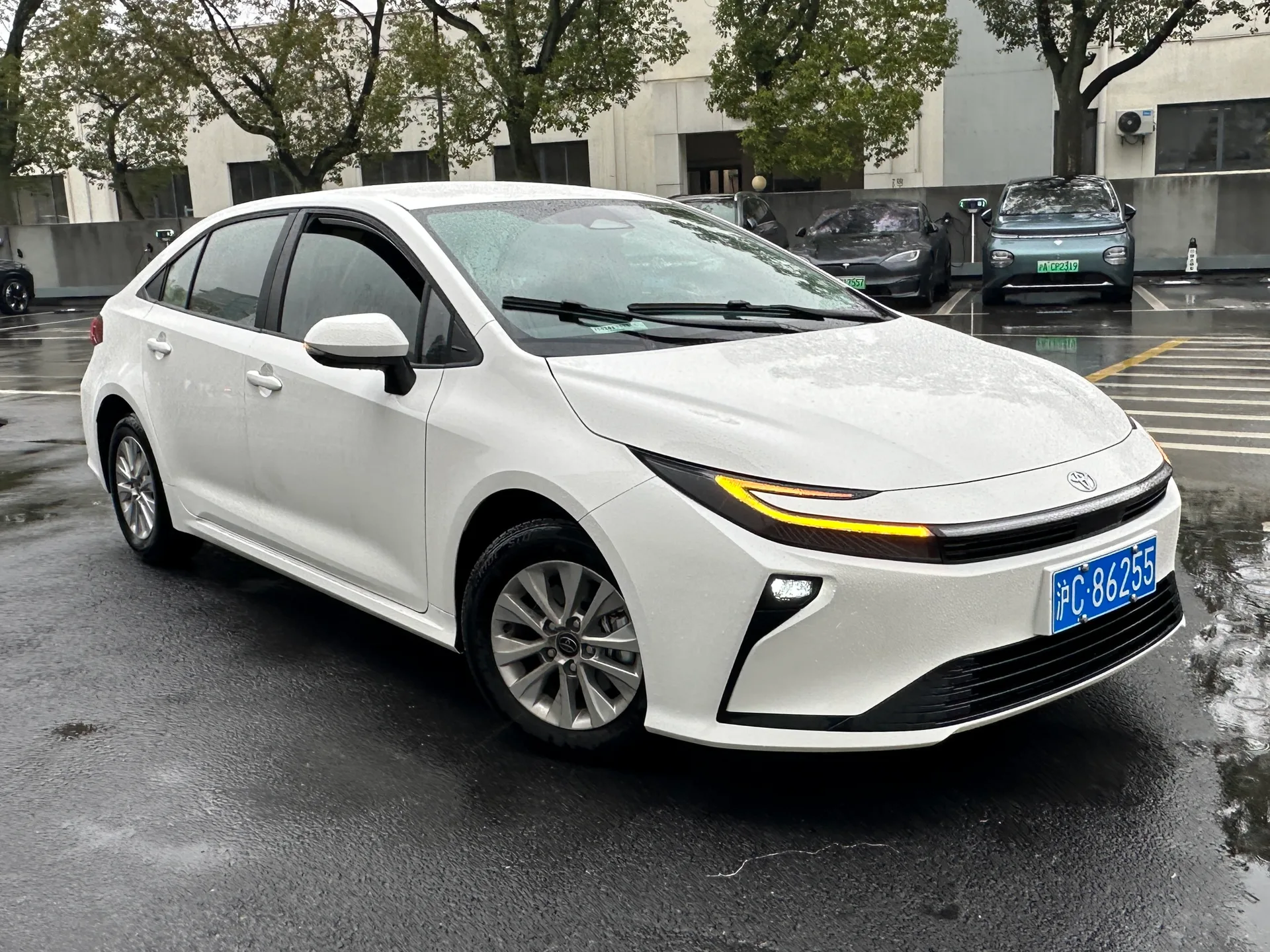 White 2026 Toyota Corolla facelift sedan shown from the front left