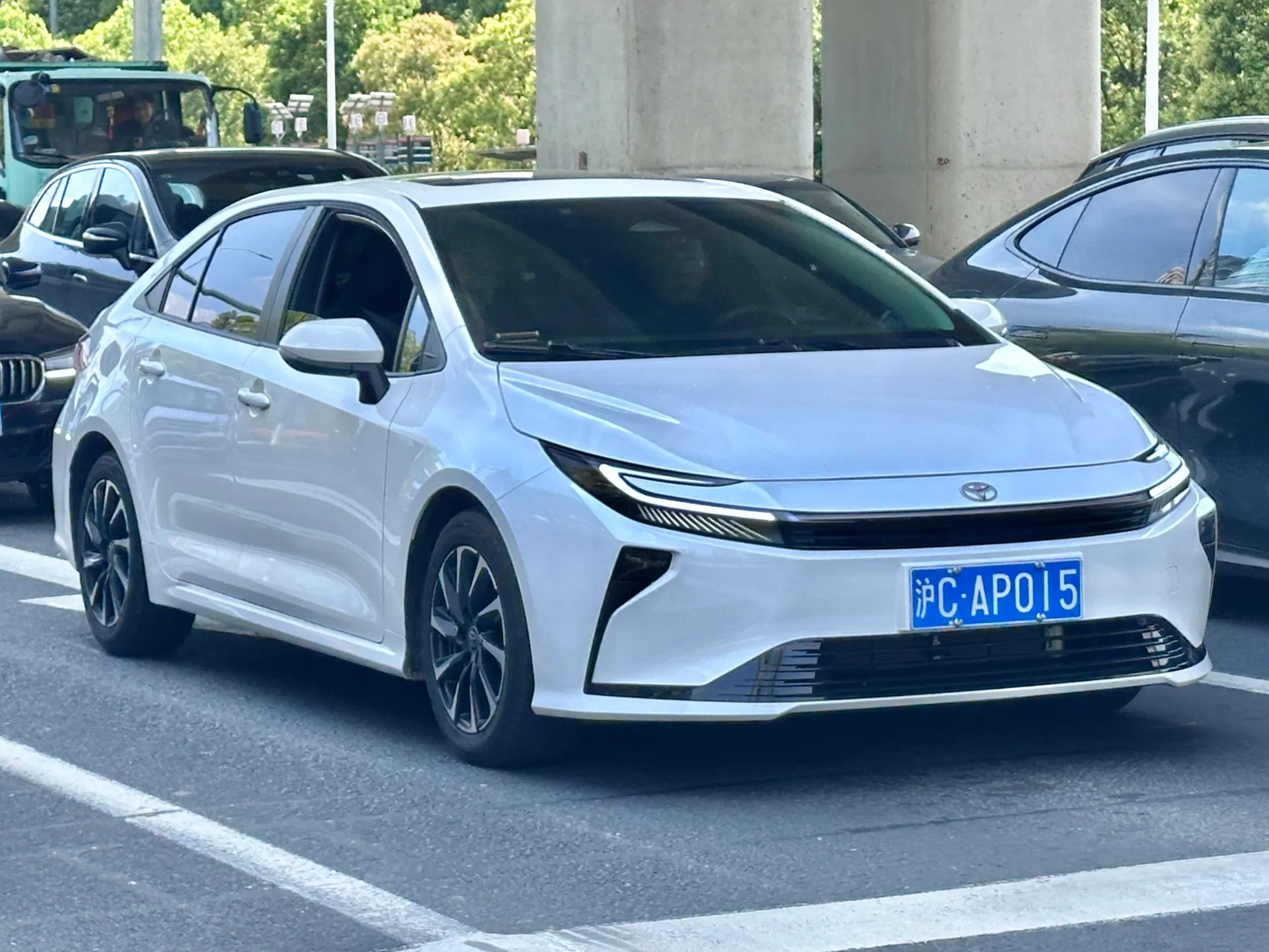 White 2026 Toyota Corolla facelift sedan shown from an alternate front-left angle