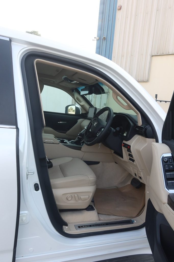Toyota Land Cruiser ZX driver cockpit with beige leather and multifunction steering wheel