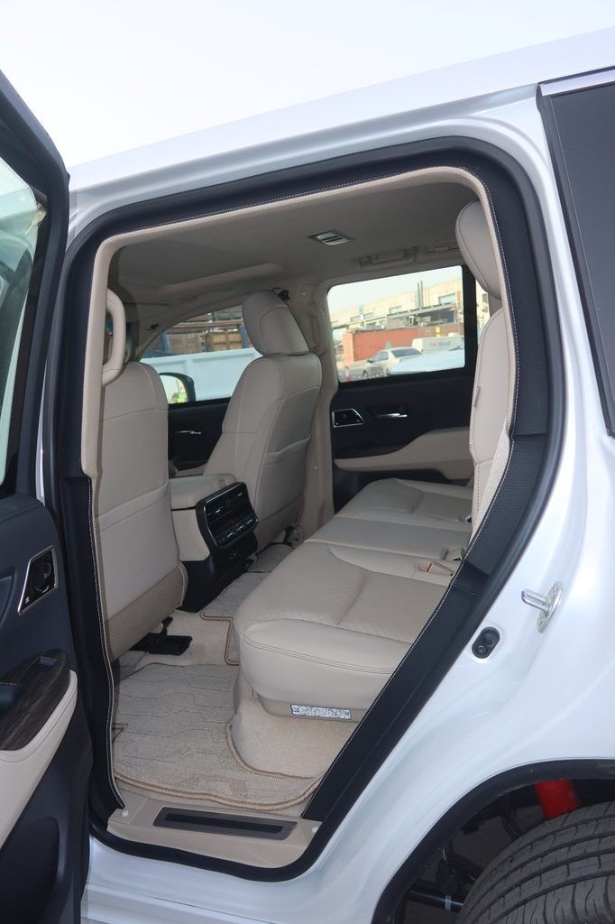 Toyota Land Cruiser ZX interior door panel with beige upholstery and controls