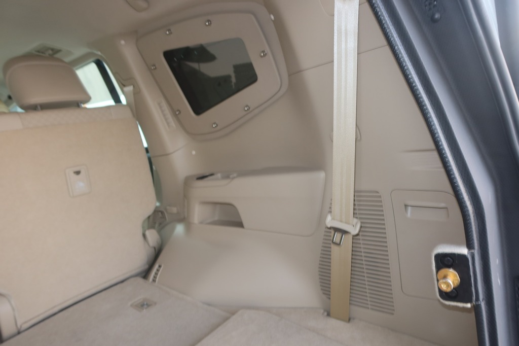 Toyota Land Cruiser ZX interior safety details with seatbelt mounting and beige trim