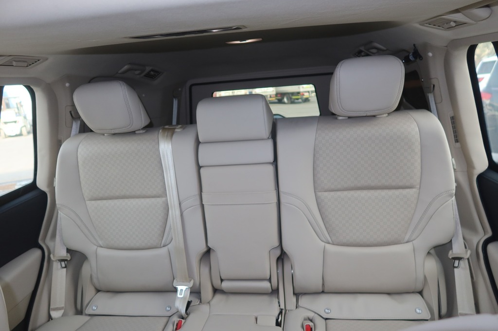 Toyota Land Cruiser ZX second-row seating with beige leather and folding armrest
