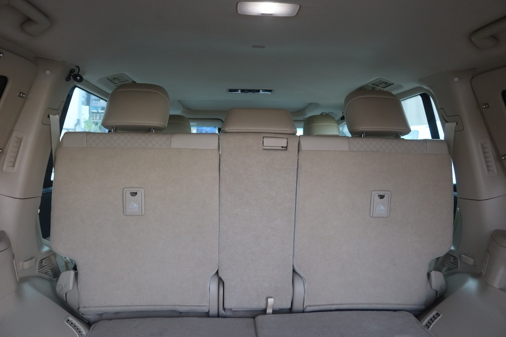 Toyota Land Cruiser ZX third-row seating with beige interior and overhead lighting