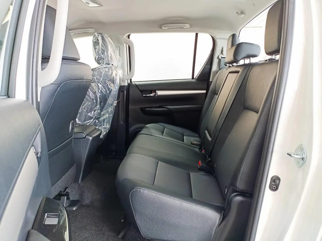 Toyota RHD Hilux 2.8L DC armored pickup rear seats left side view