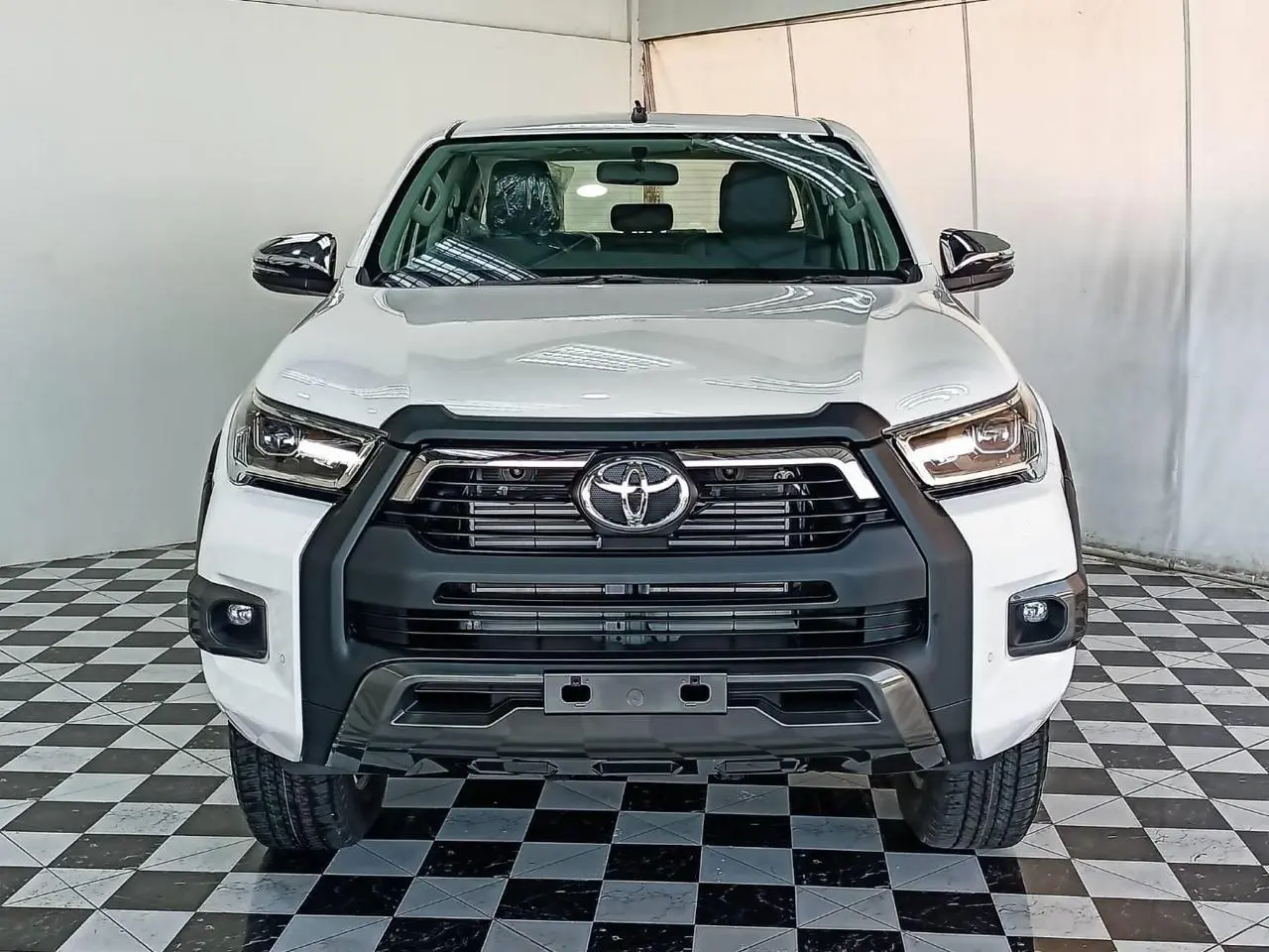 Toyota RHD Hilux 2.8L DC armored pickup front view with lights on
