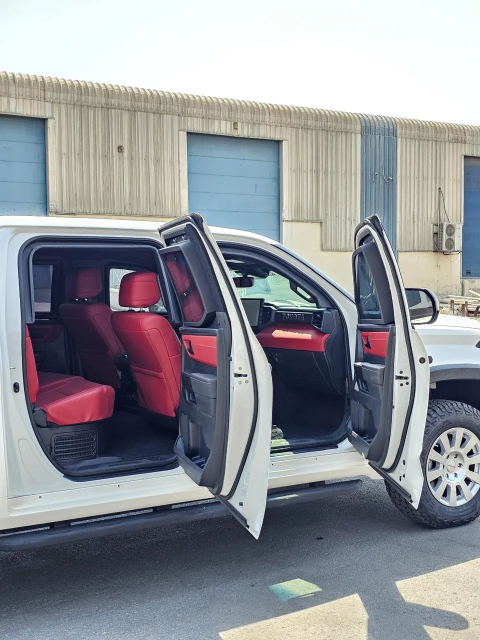 2027 Toyota Tundra BR7 passenger cabin with armored doors open and red leather seats
