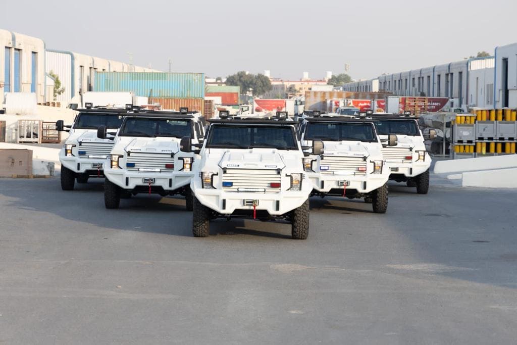 white mrap vehicles parked in a v shape